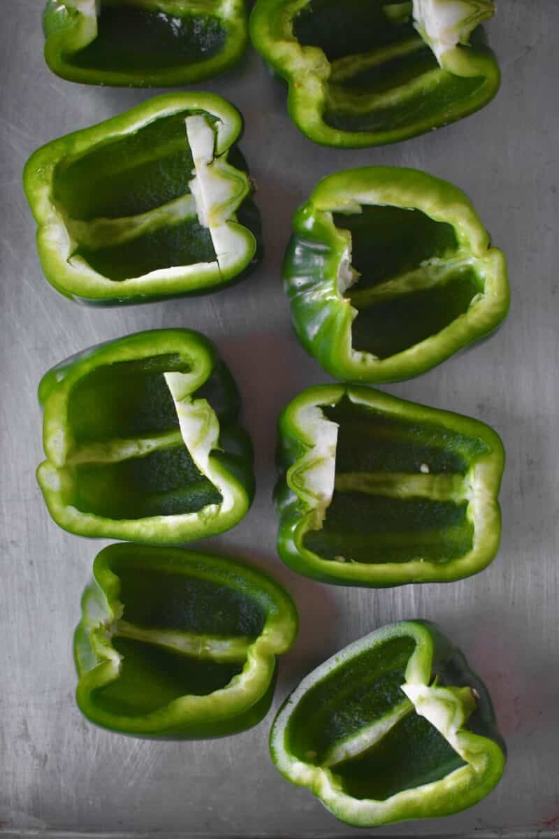 Halved bell peppers that have had the seeds and ribs removed.