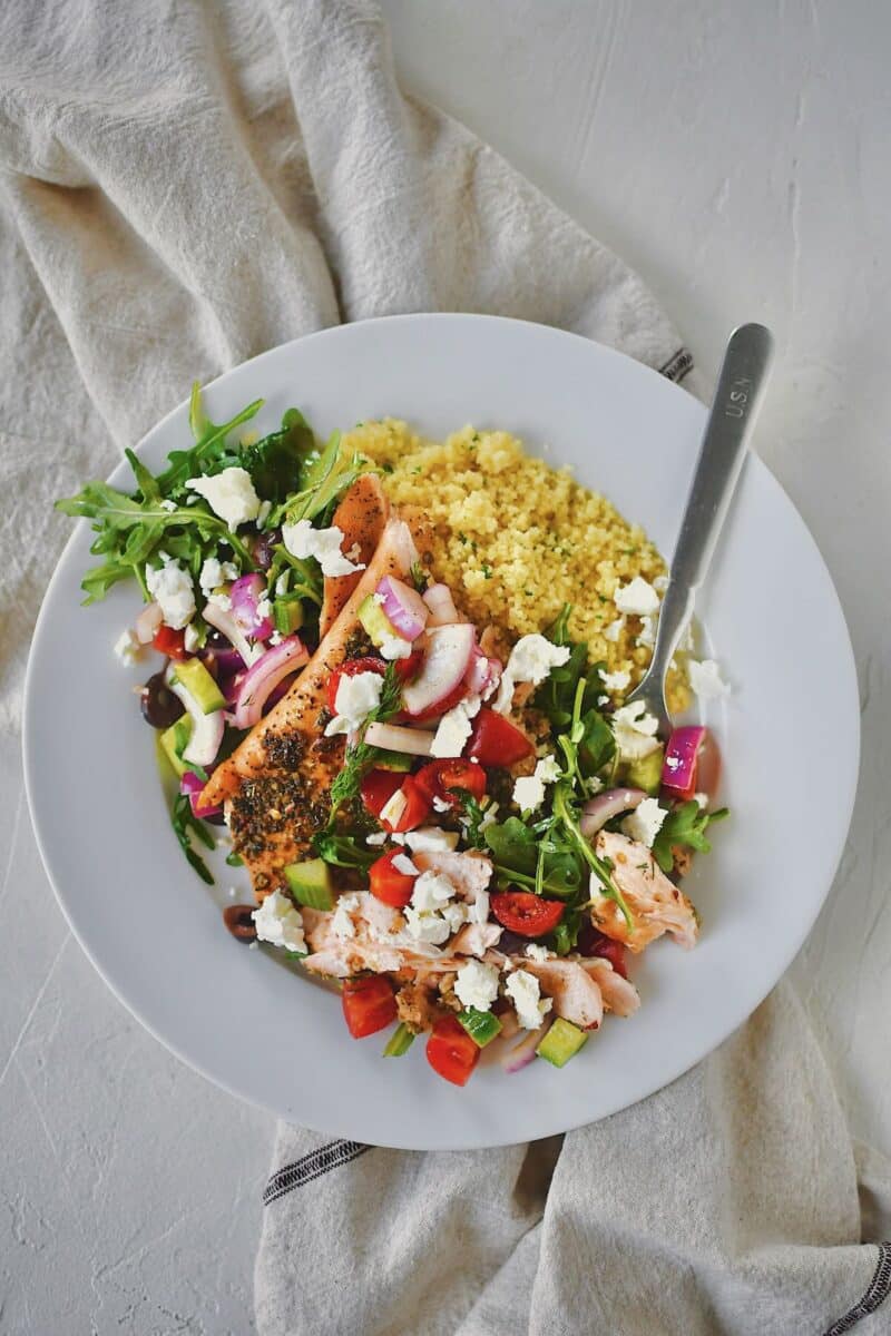 Greek Salmon topped with Greek salad topping of fresh veggies and feta cheese.