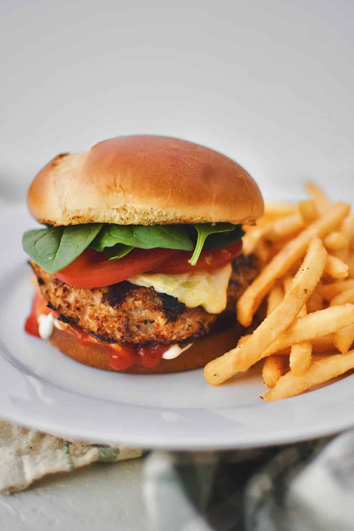 Assembled Turkey Burger on a plate with fries.