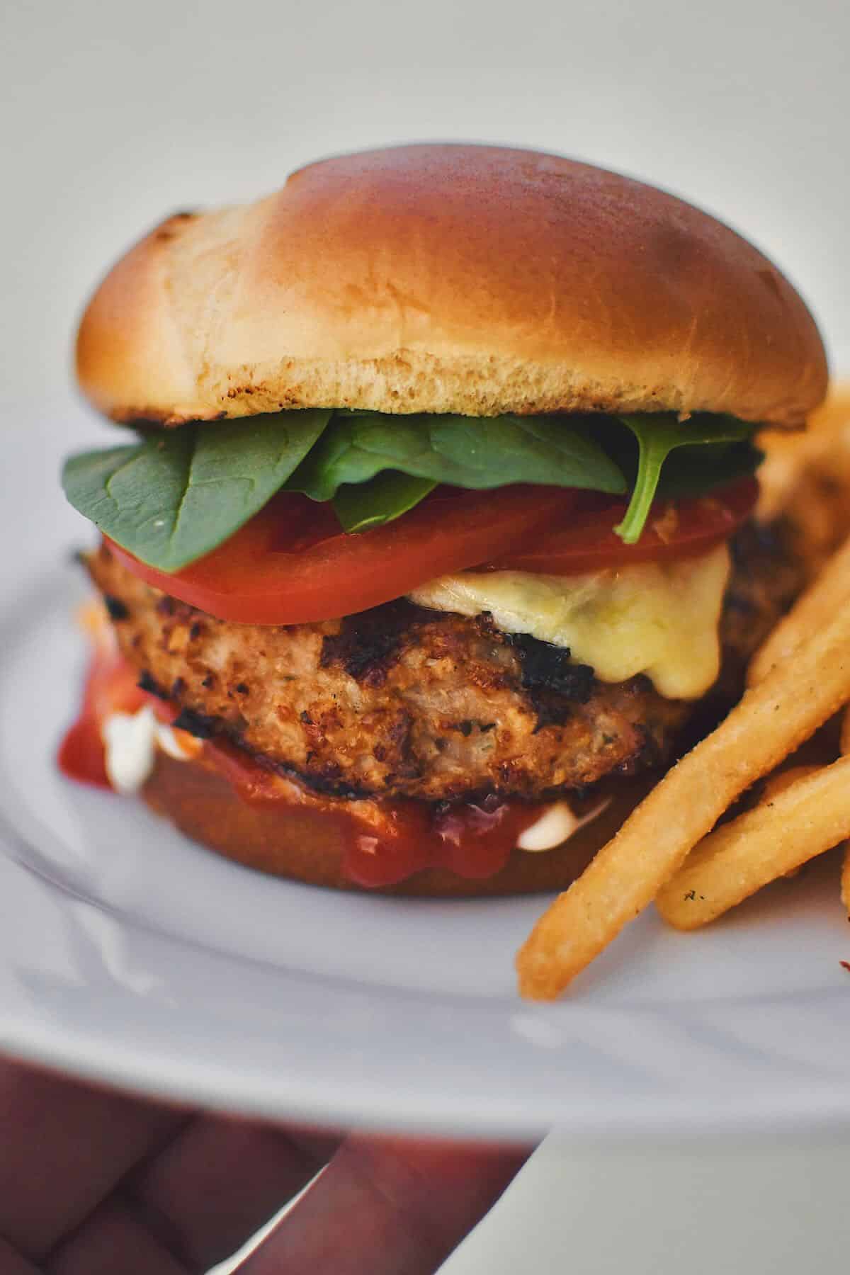 Assembled Turkey Burger on a plate with fries.