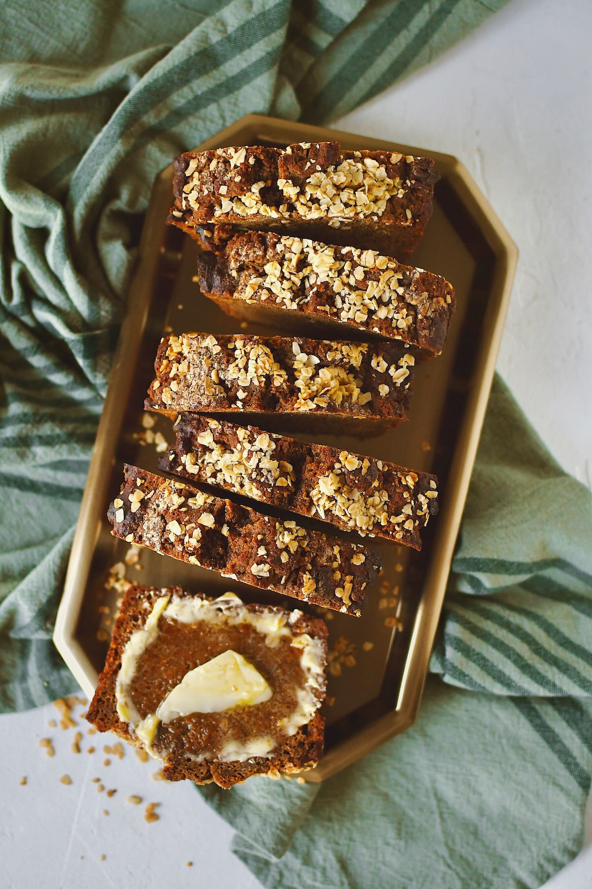 Irish Brown Bread sliced and ready to eat. One slice with some butter spread on it.