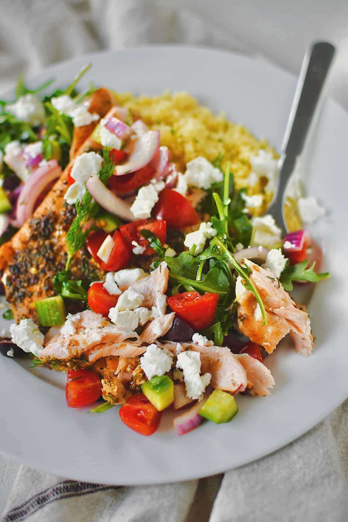 Greek Salmon topped with Greek salad topping of fresh veggies and feta cheese.