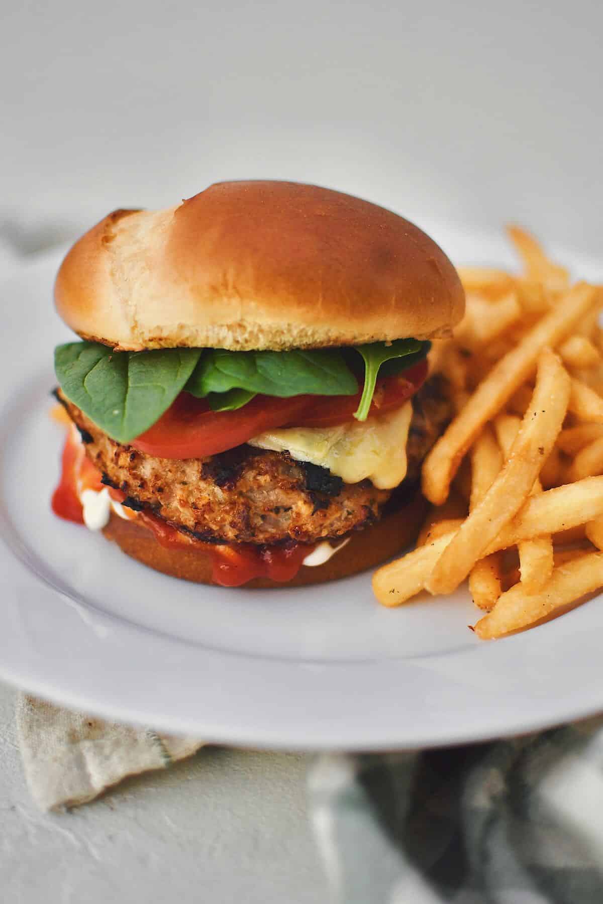 Assembled Turkey Burger on a plate with fries.