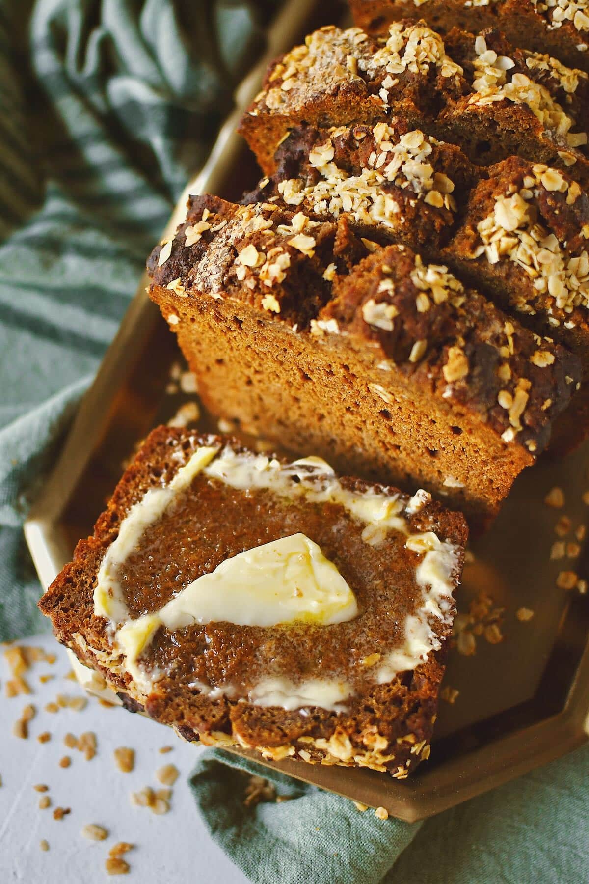 Irish Brown Bread sliced and ready to eat. One slice with some butter spread on it.