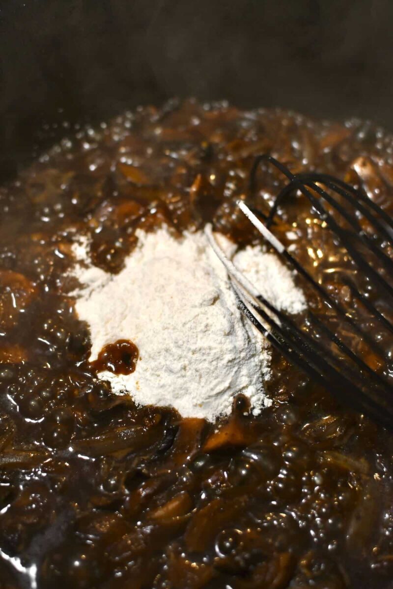 Whisking in the flour to thicken the soup.