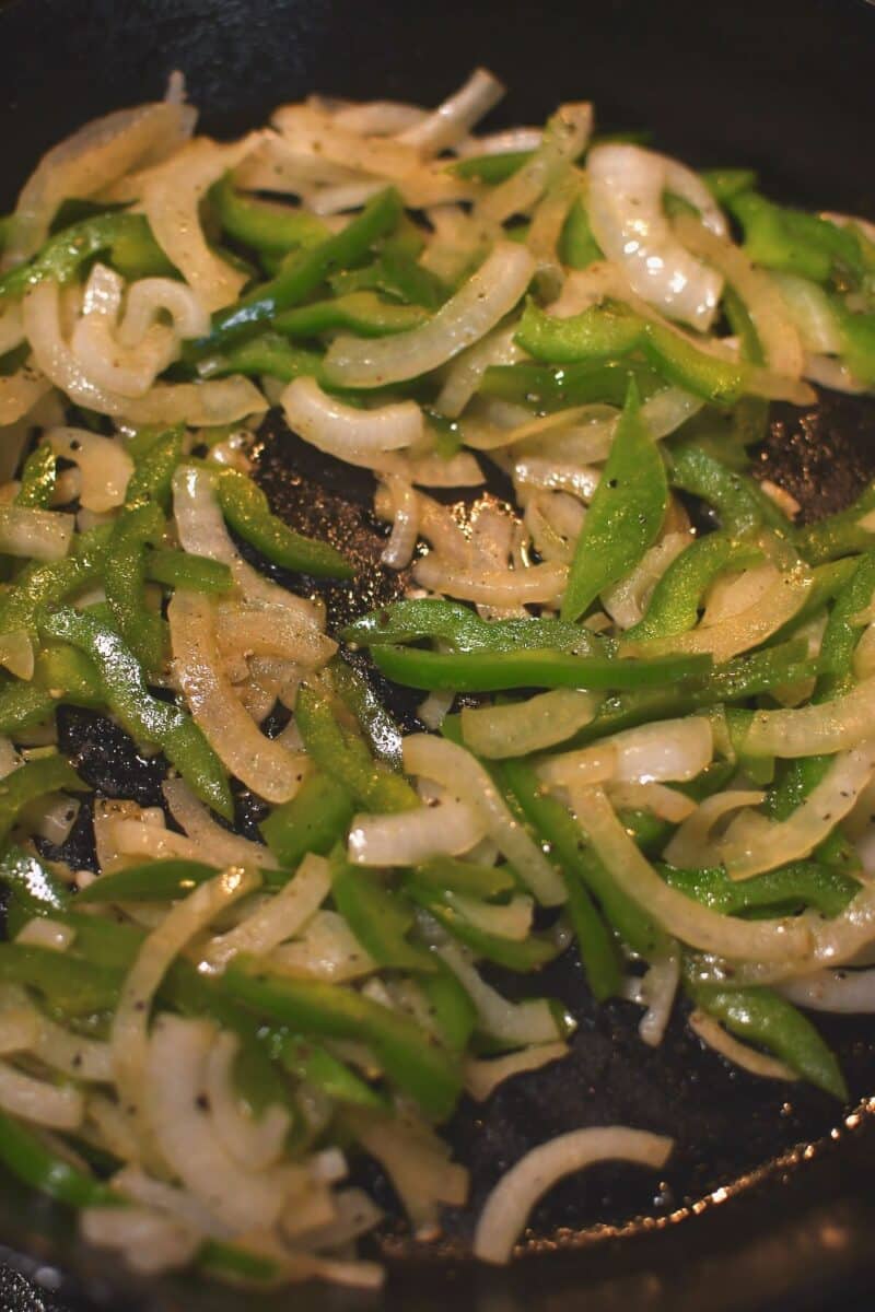 Sauteing the onions and bell peppers in some butter till soft.