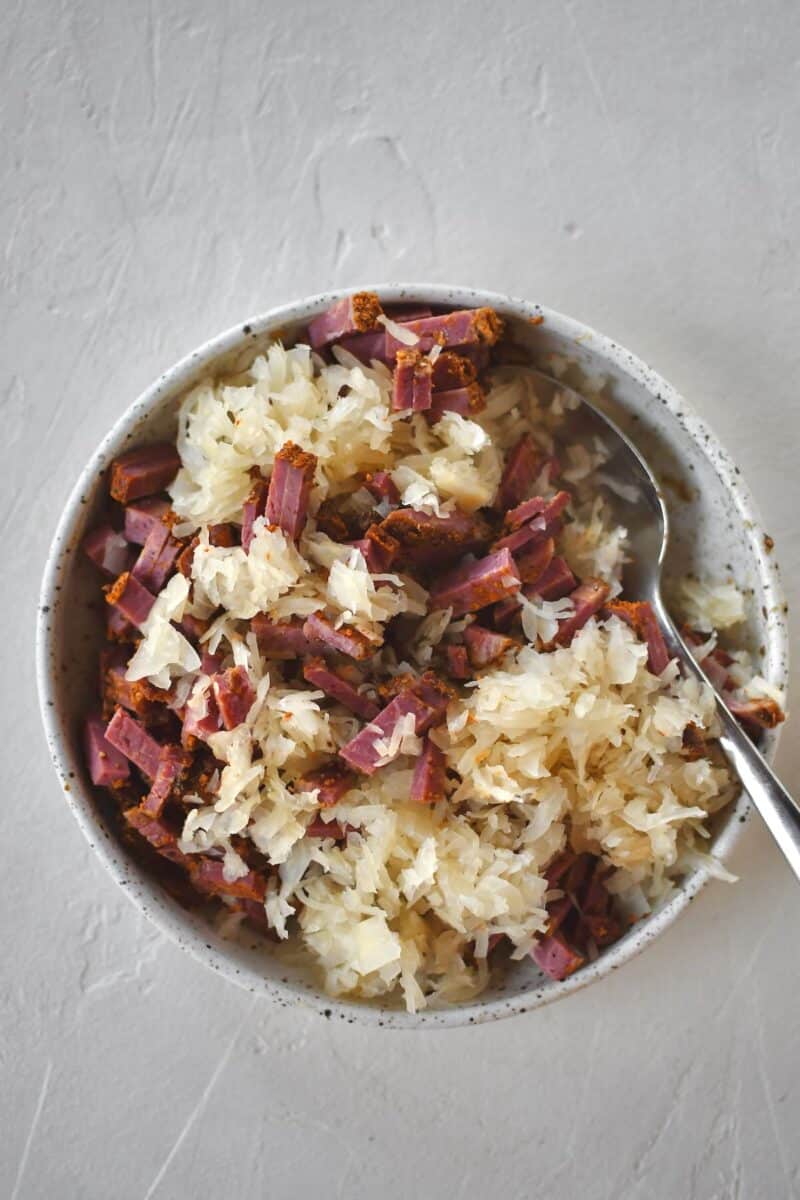 Reuben egg roll filling mixed up in a bowl.