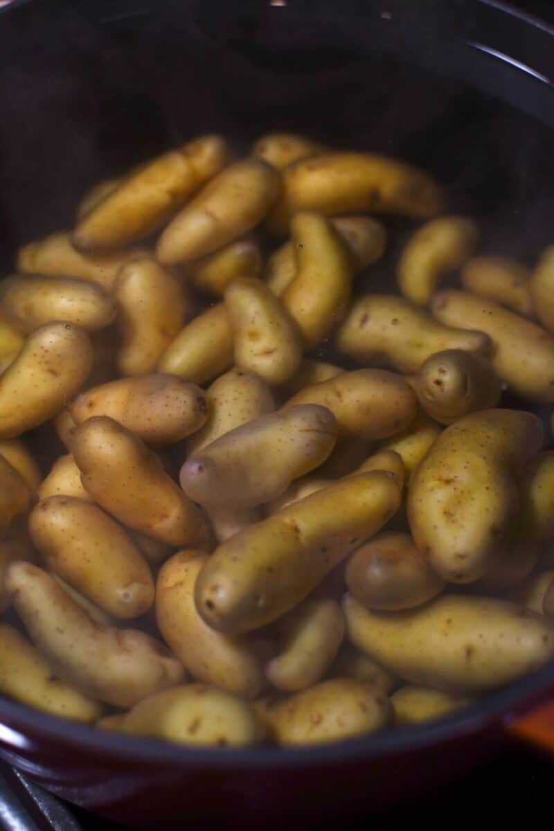 Potatoes placed in boiling water to be par cooked before smashing.