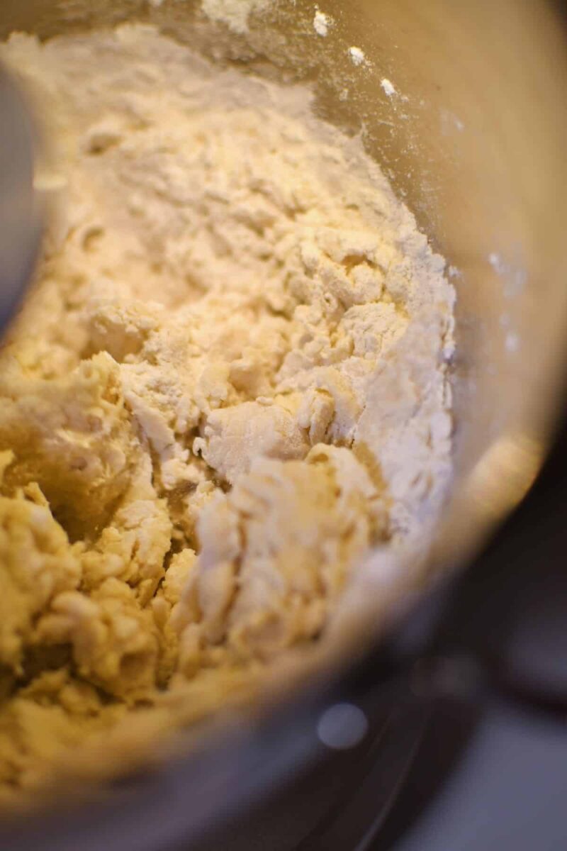 A shaggy dough forming in the stand mixer for pretzel dough.