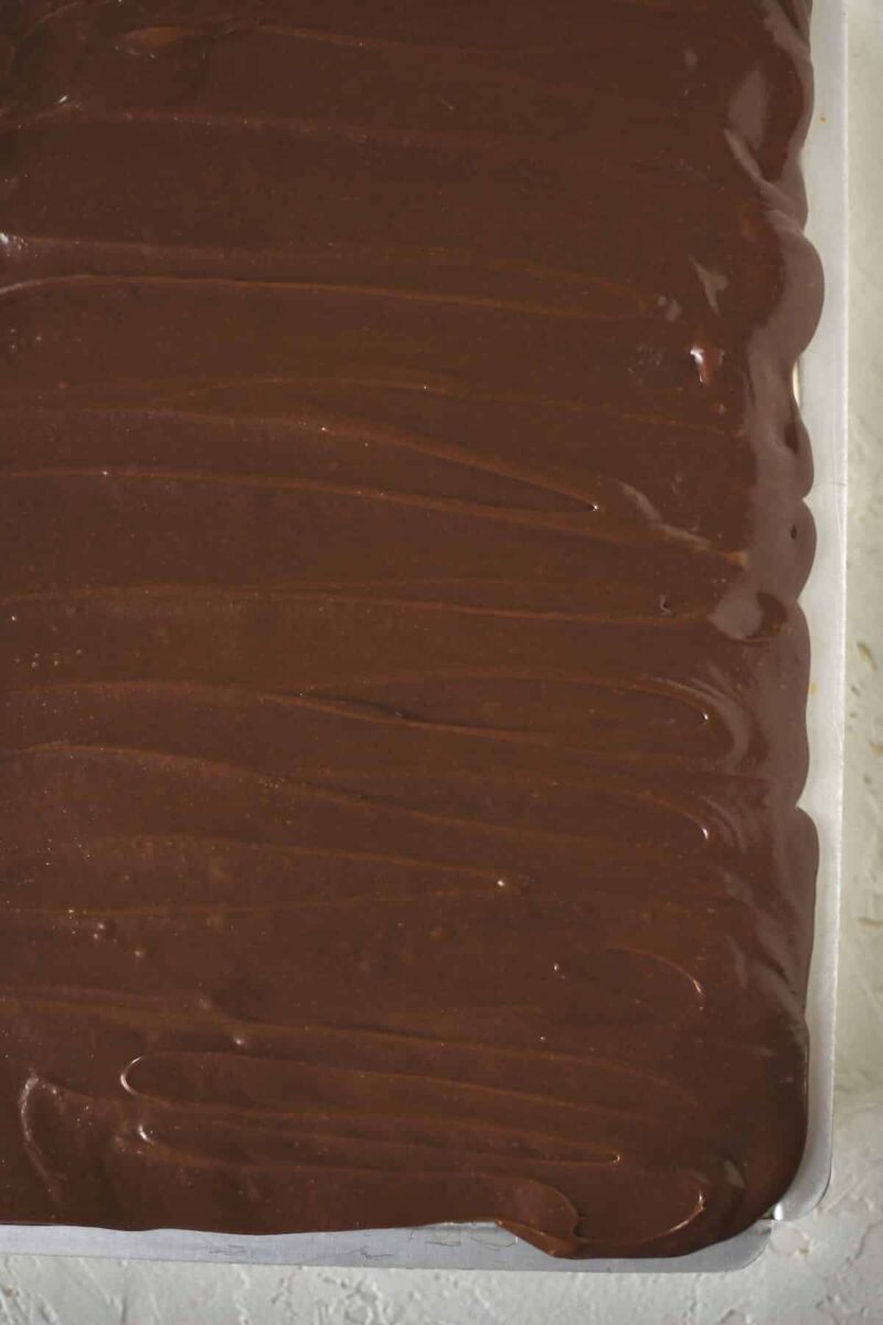 Evenly spread chocolate frosting over the finished Eclair Cake.