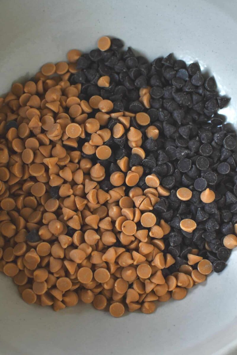 Adding the peanut butter and chocolate chips to a bowl so they can be melted together.