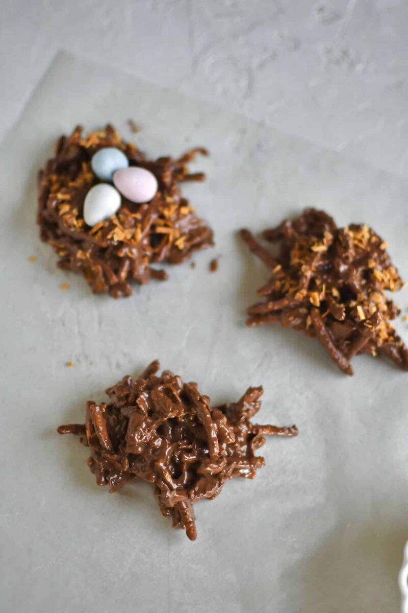 Dropping dollops of cookies on wax paper, adding egg candies when making for easter.