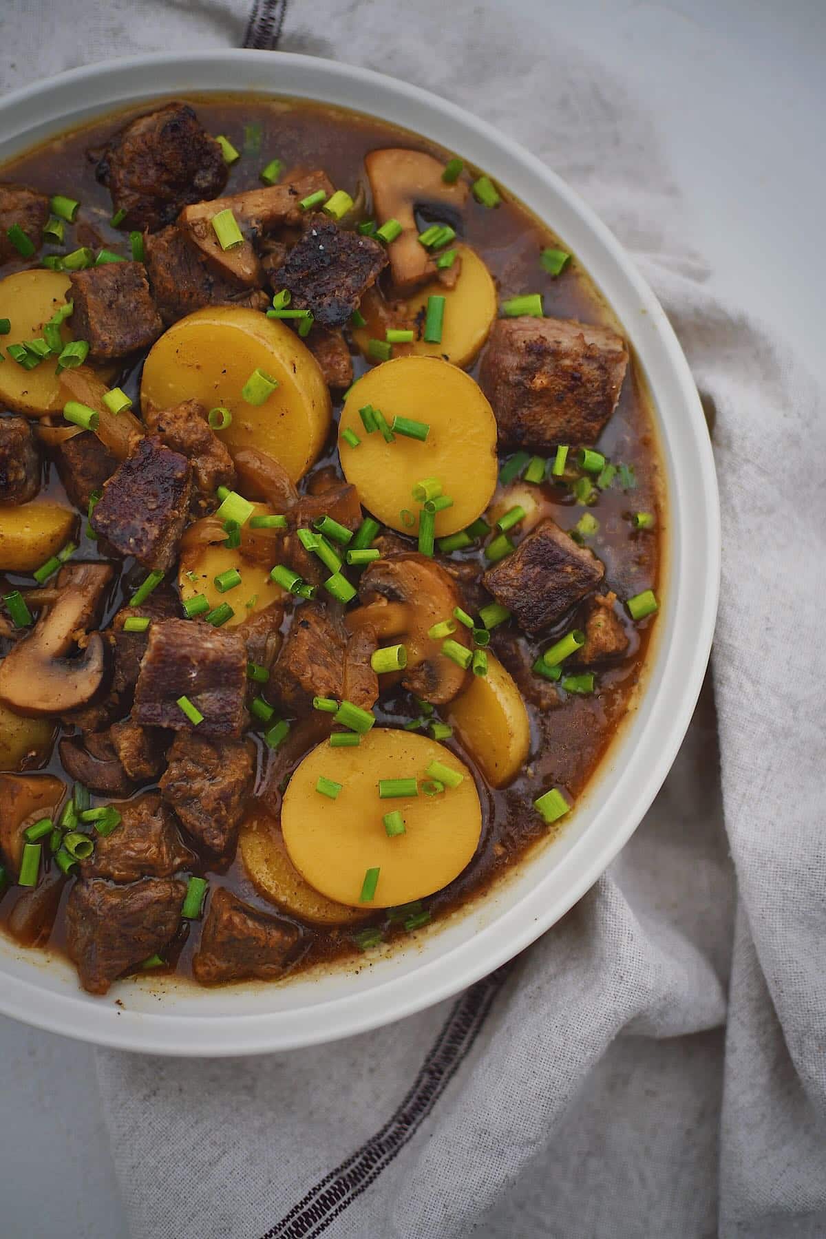 Steak and Potato Soup in a bowl ready to be eaten.