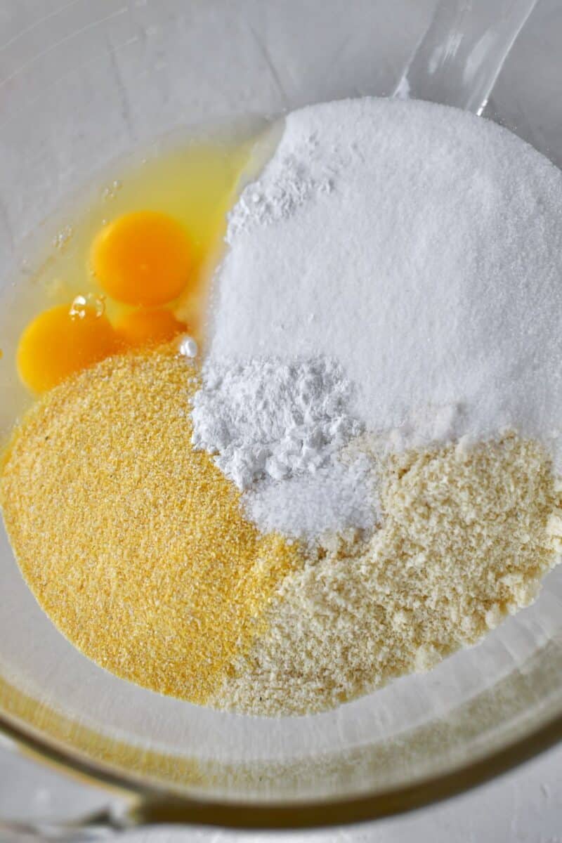 Placing the eggs, almond flour, polenta, sugar, baking powder, and salt in a stand mixer bowl.