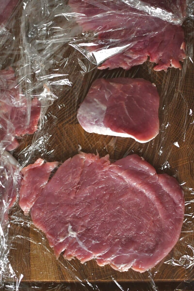 Pounding out pork tenderloin pieces to make cutlets.