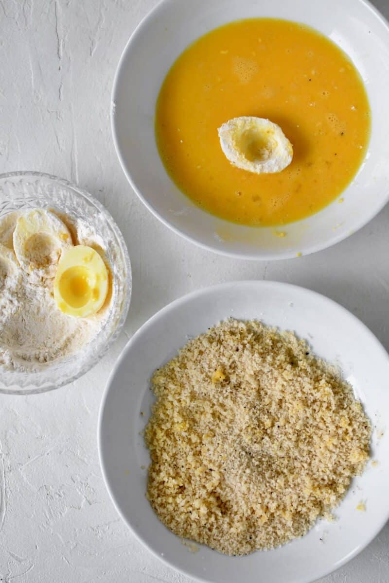 Breading station for the egg whites. Dusing in flour, dippin in egg yolks, then dreading in panko bread crumbs.