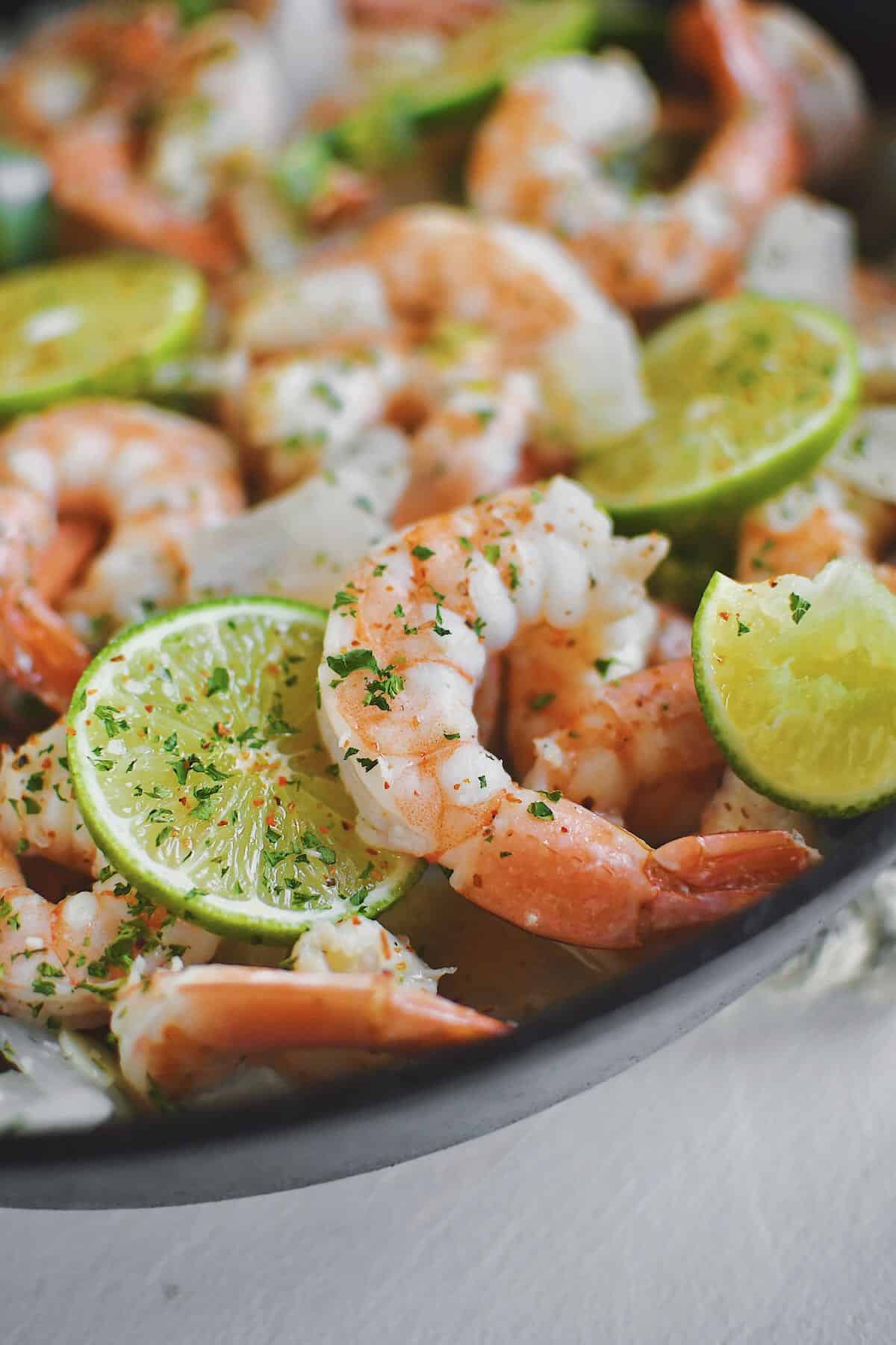 Cooked shrimp still in the pan staying warm, ready to eat.