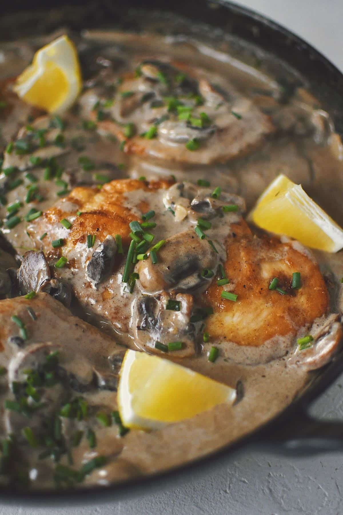 Creamy Mushroom Chicken, finished in the pan and topped with chives and a squeeze of lemon.