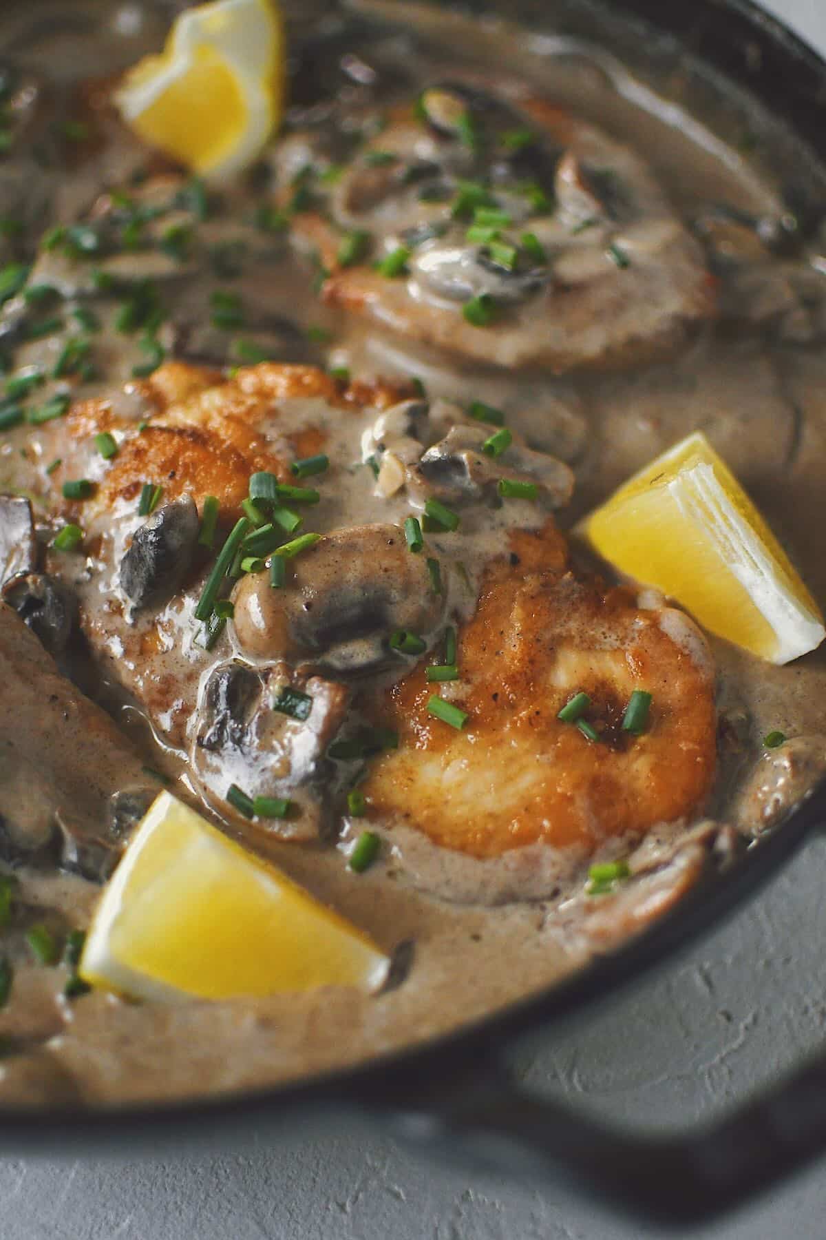 Creamy Mushroom Chicken, finished in the pan and topped with chives and a squeeze of lemon.
