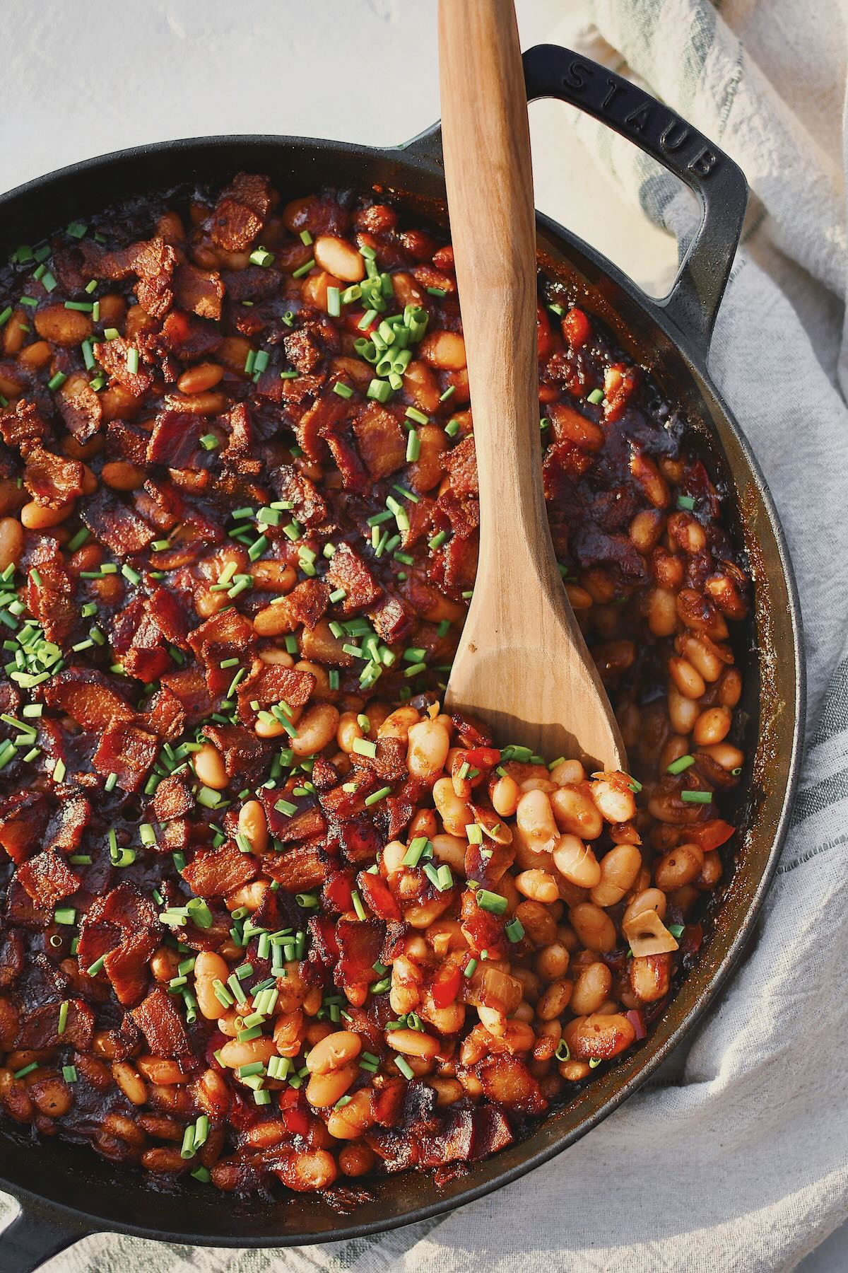 Dr. Pepper Baked Beans, just out of the oven and topped with chives. Spooning some out to eat.