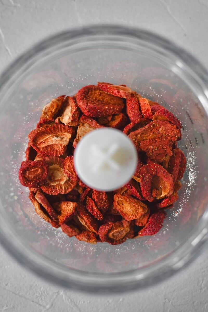 Freeze dried strawberries before crushing in a food processor.