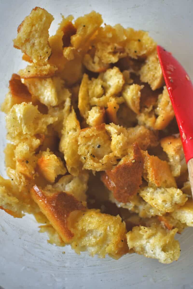 Torn bread tossed with the seasoned butter until well coated.