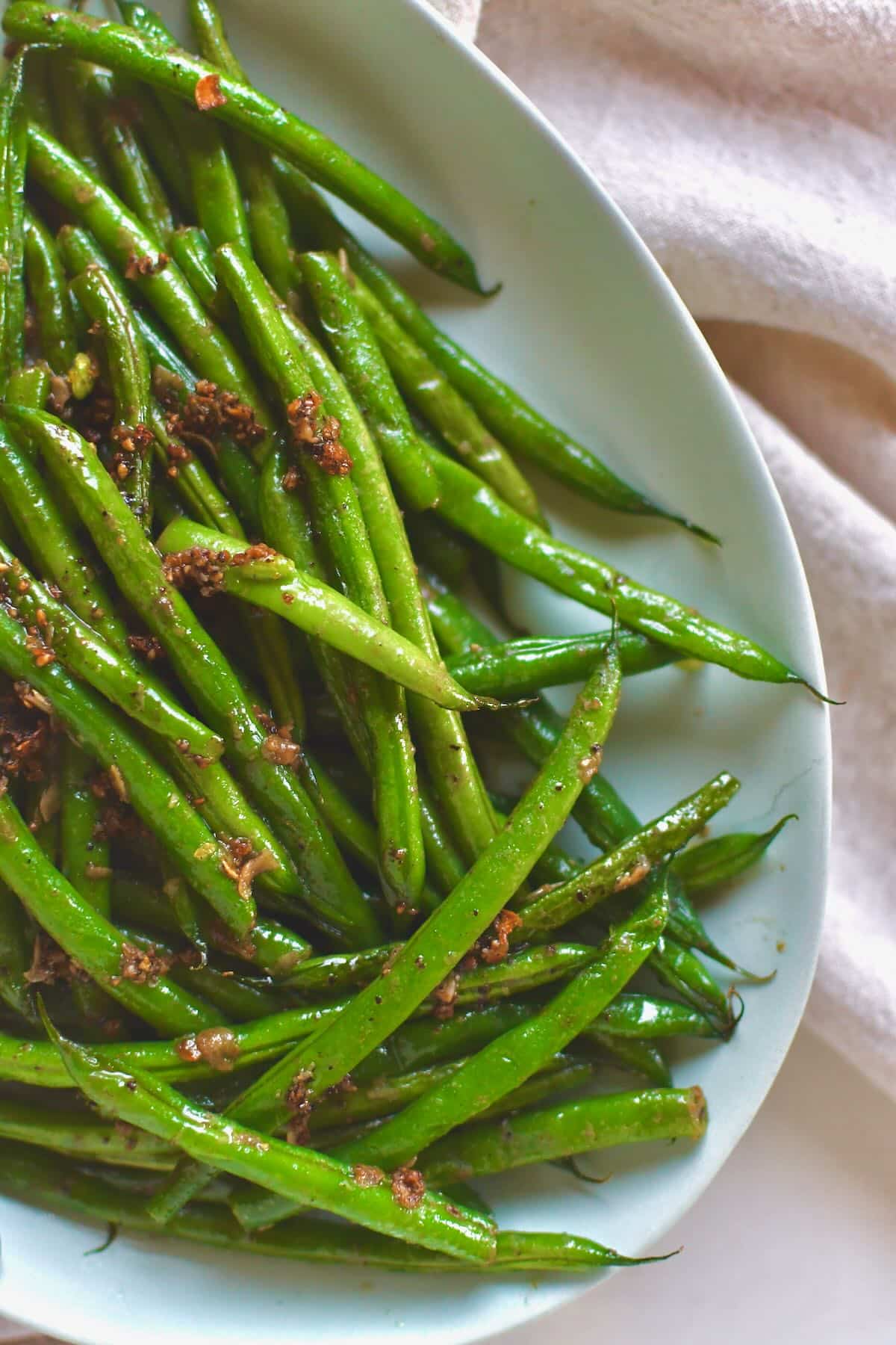 Sautéed Green Beans fresh out of the skillet with all the cooked garlic bits on top.