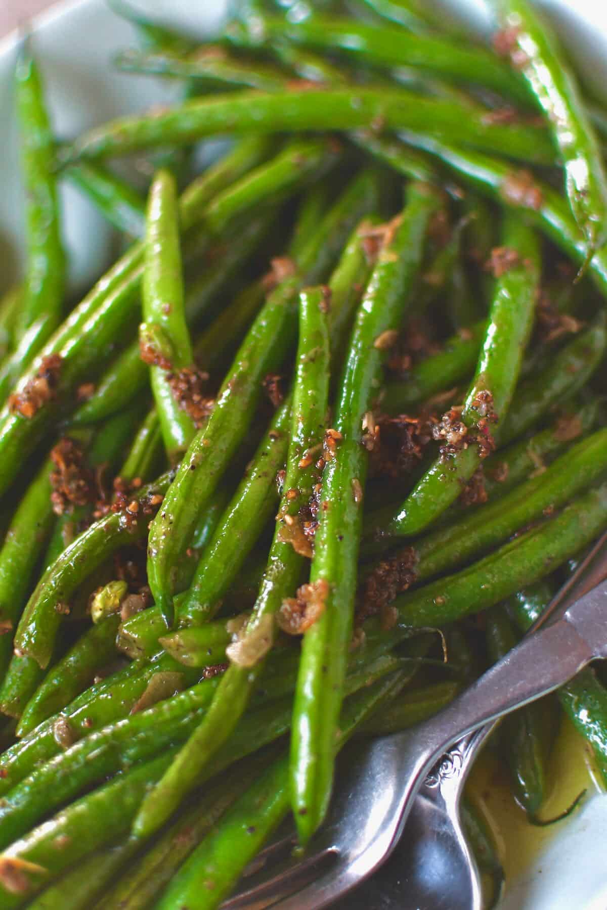 Sautéed Green Beans fresh out of the skillet with all the cooked garlic bits on top.