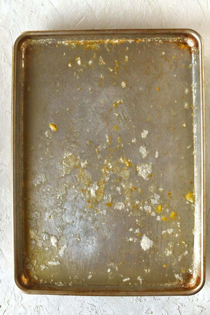 Solid butter placed on a rimmed baking sheet after melting.
