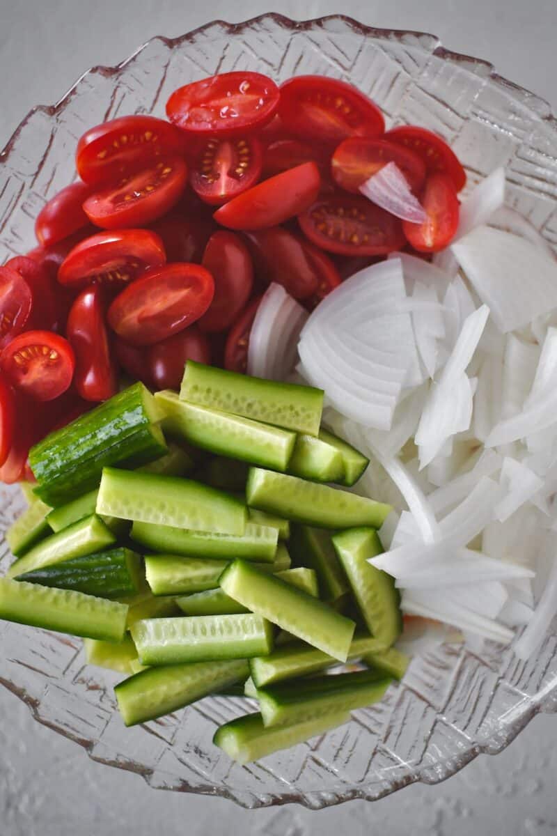 Chopped vegetables placed in the bowl with the marinade.