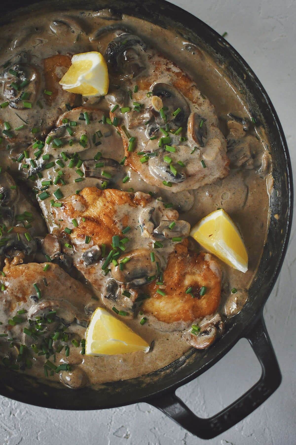 Creamy Mushroom Chicken, finished in the pan and topped with chives and a squeeze of lemon.