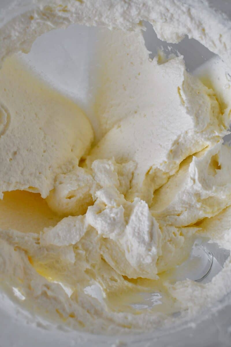 Cream cheese, ricotta, and mascarpone, creamed together in the bowl of a stand mixer.