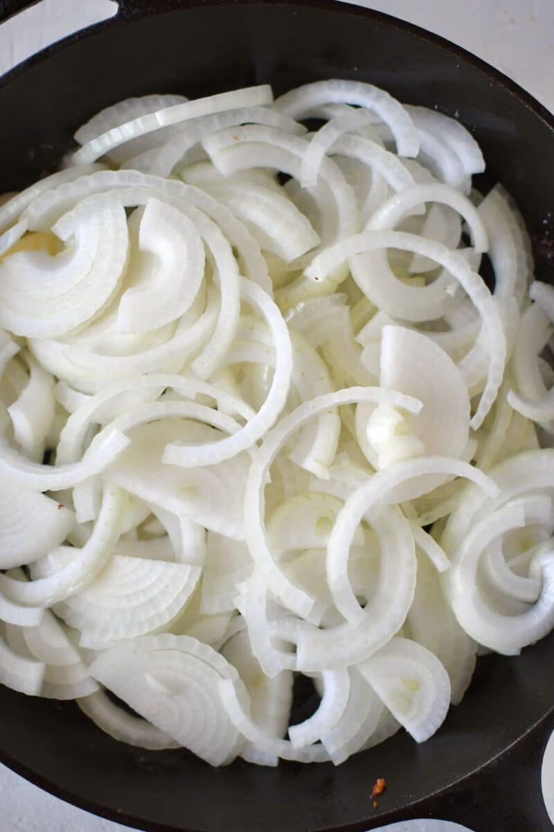 Onions and butter added to a hot skillet.