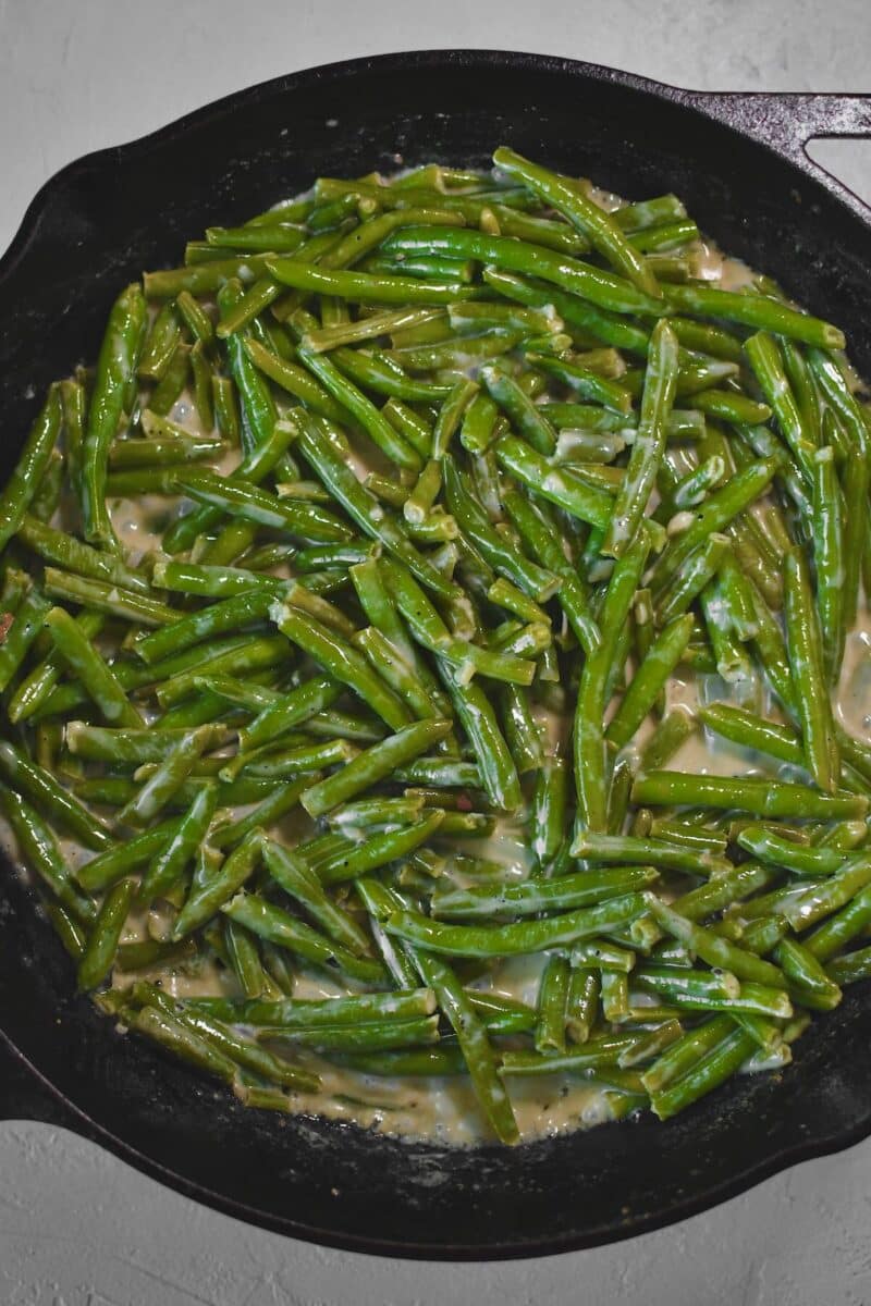 Green beans tossed in the cream sauce till it beings to cling.