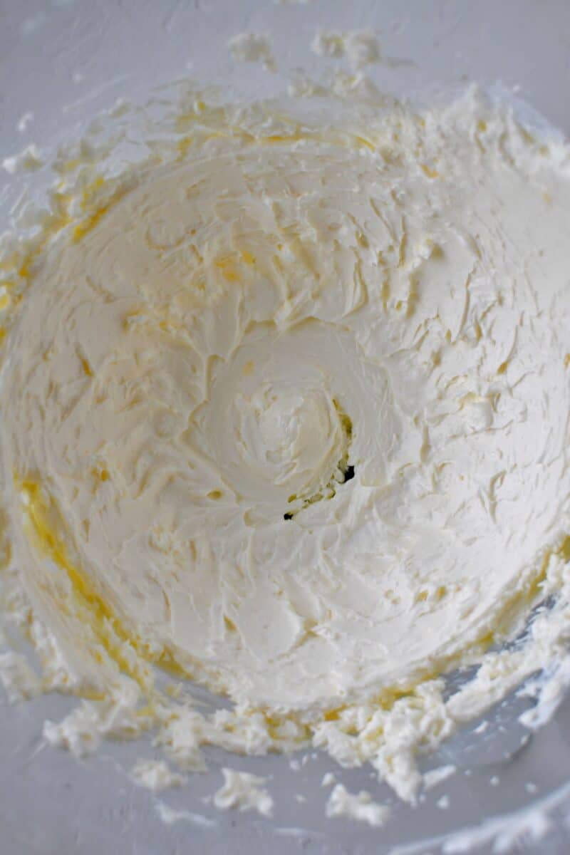 Whipped cream cheese in a stand mixer bowl.