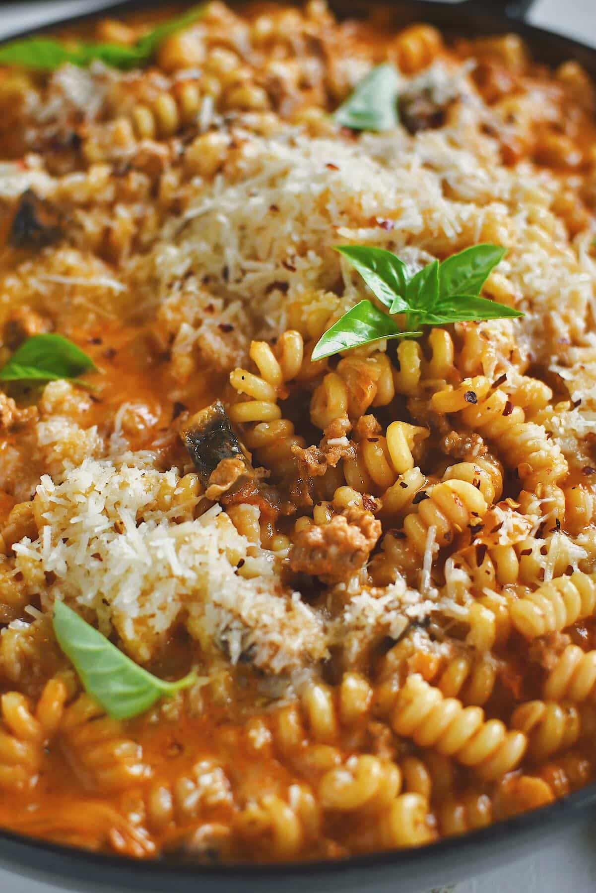 Italian Sausage Pasta finished in the pan and topped with extra parmesan and basil.