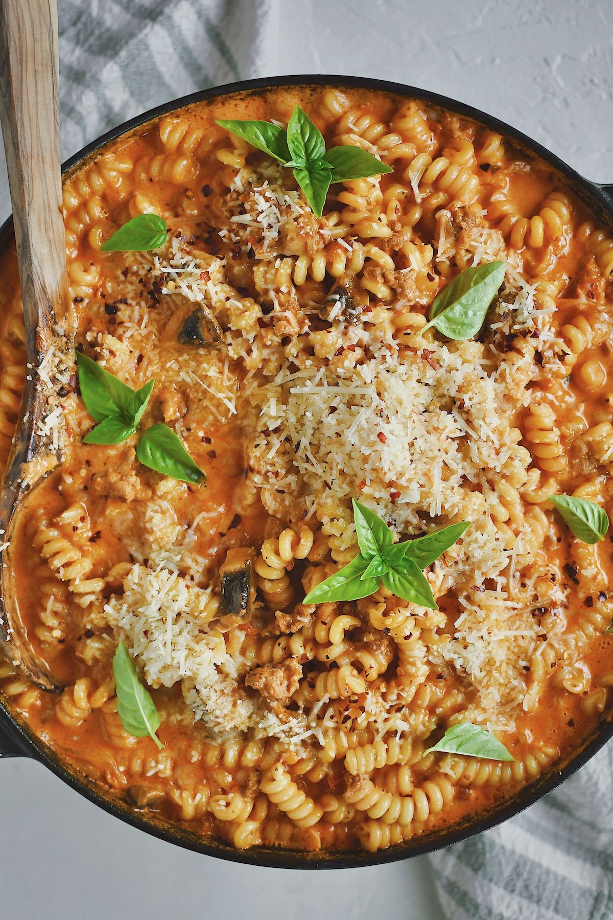 Italian Sausage Pasta finished in the pan and topped with extra parmesan and basil.