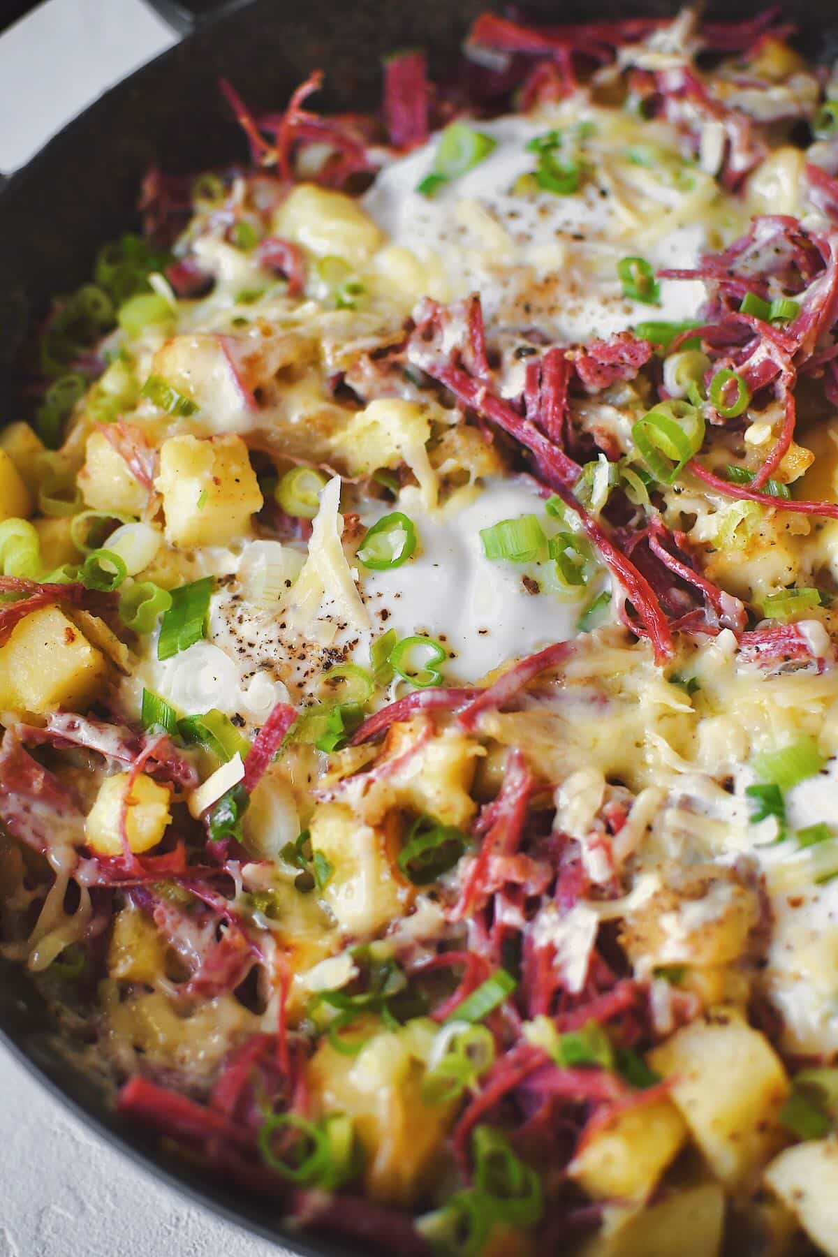 Eggs cracked into the corned beef hash, and cooked just till the whites have set.