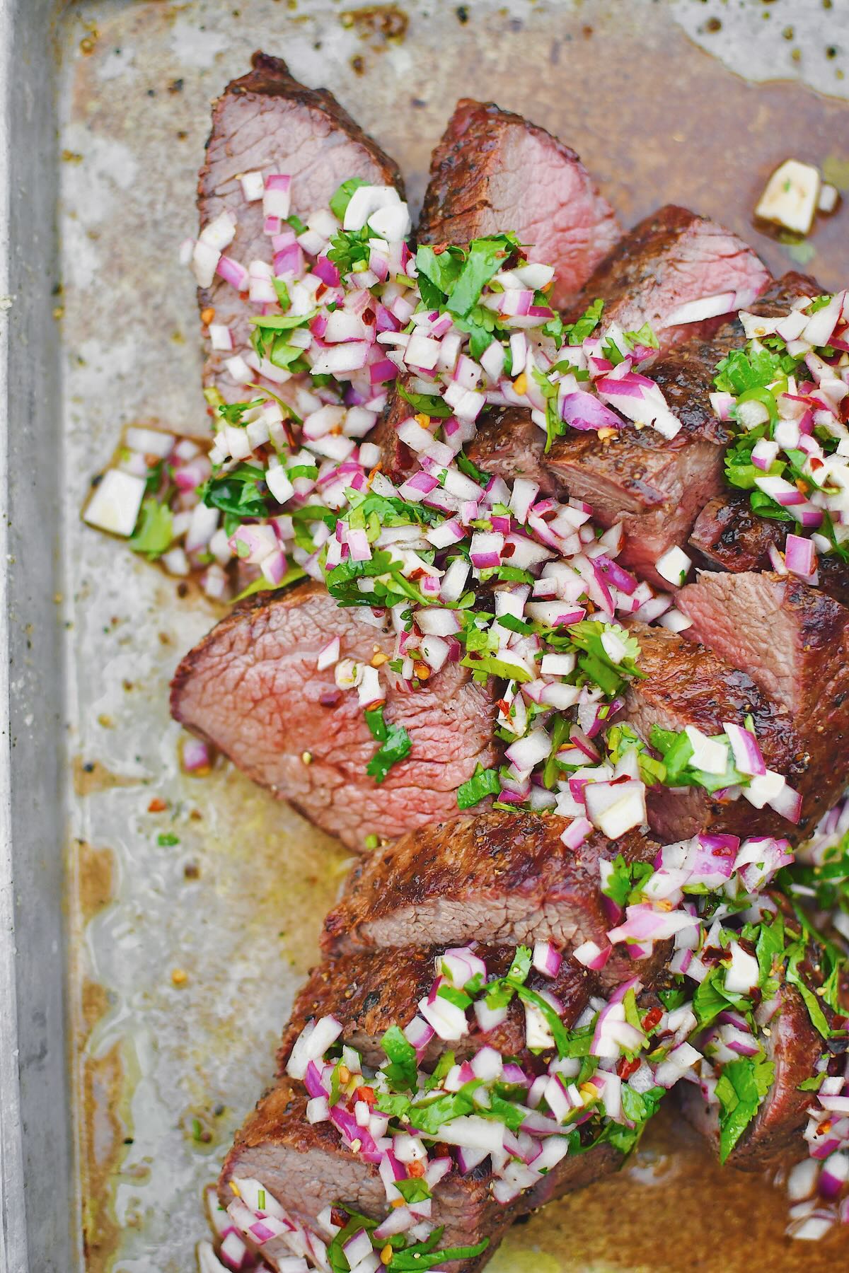 Tri-Tip, sliced against the grain, in two different directions, as is common with this cut of meat. Topped with an onion, cilantro, and vinegar relish.