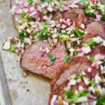 Tri-Tip, sliced against the grain, in two different directions, as is common with this cut of meat. Topped with an onion, cilantro, and vinegar relish.