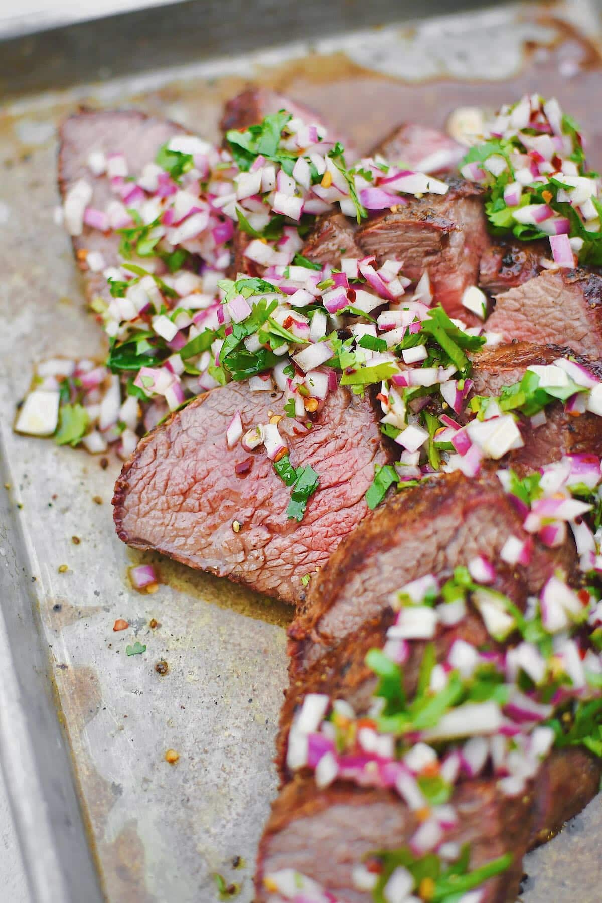 Tri-Tip, sliced against the grain, in two different directions, as is common with this cut of meat. Topped with an onion, cilantro, and vinegar relish.