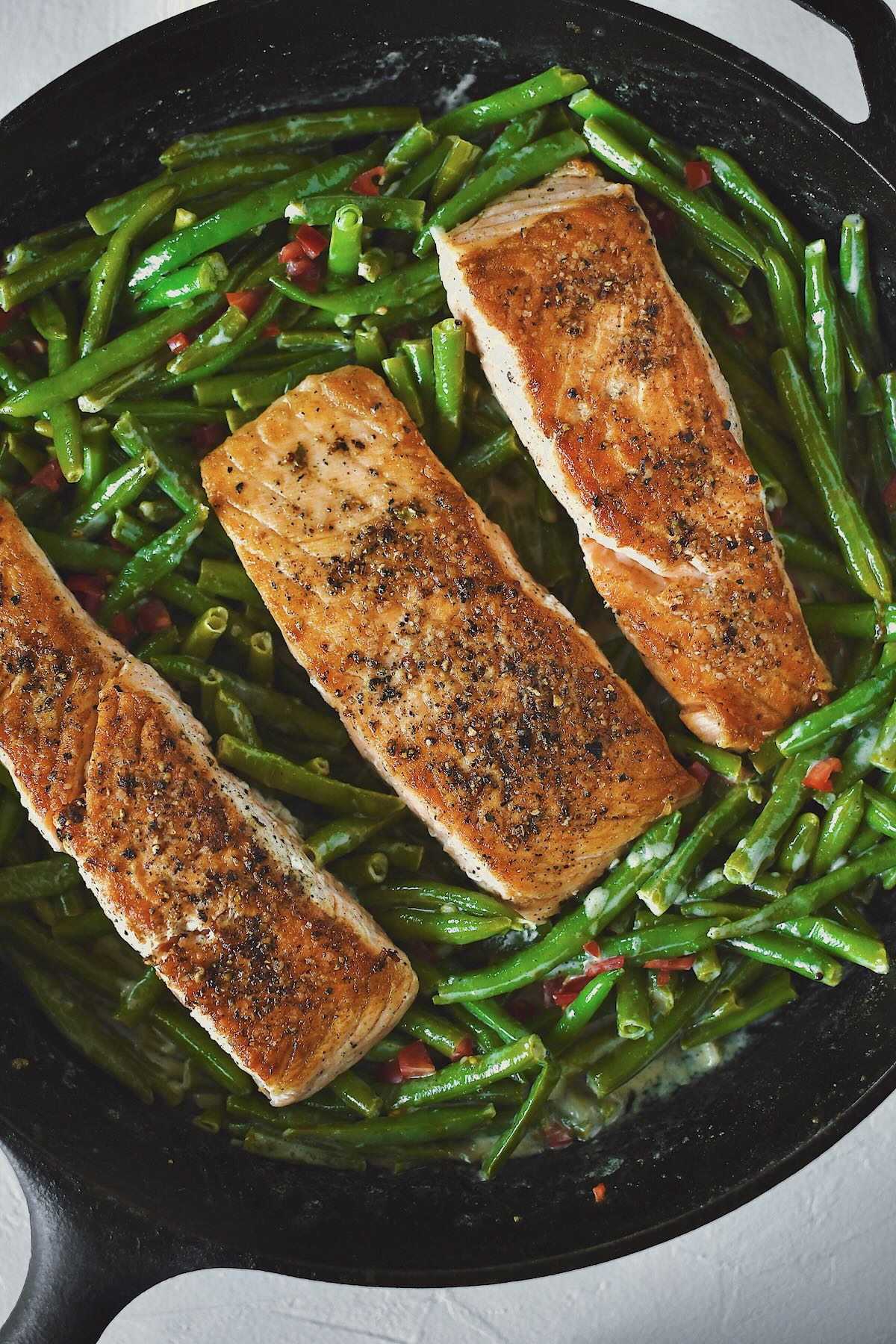 Pan Seared Salmon fillets nestled into some sauteed green beans.