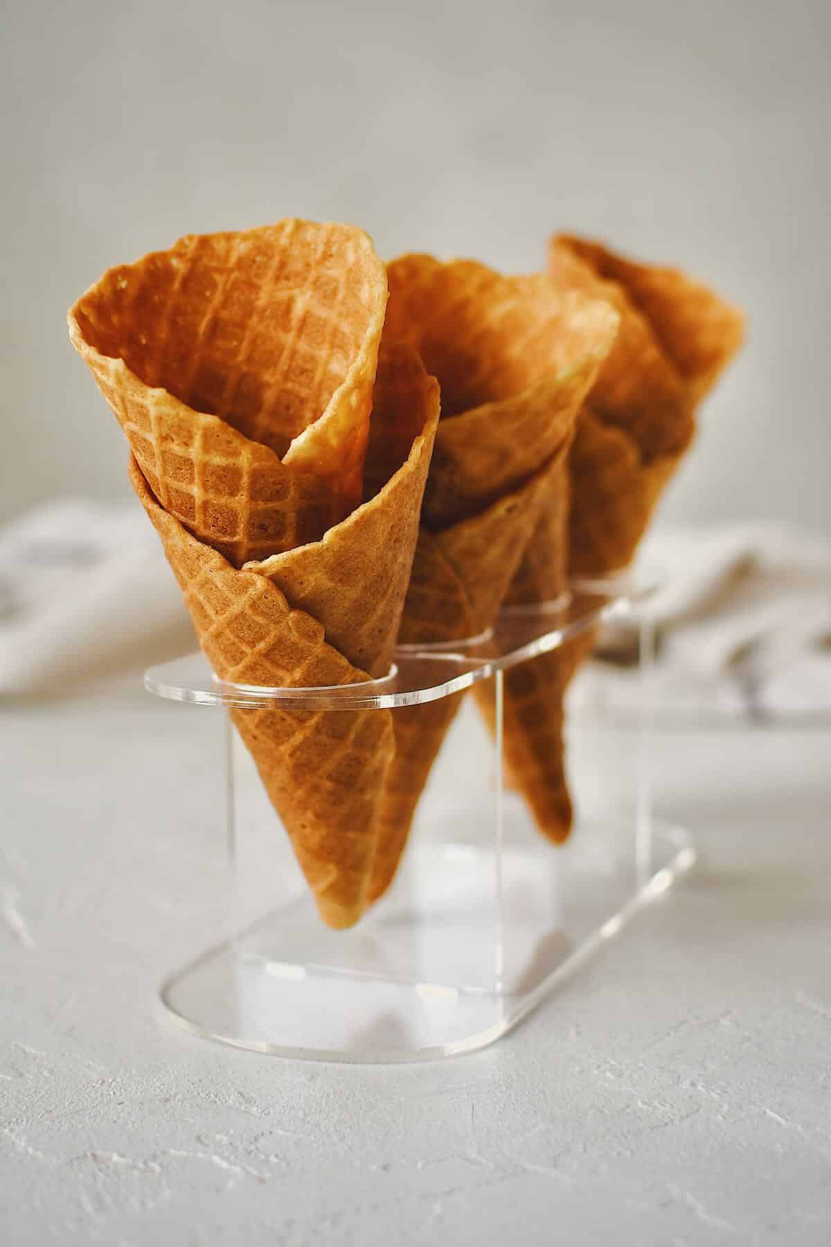 Finished Waffle Cone Recipe resting in a stand and ready to be filled with ice cream.