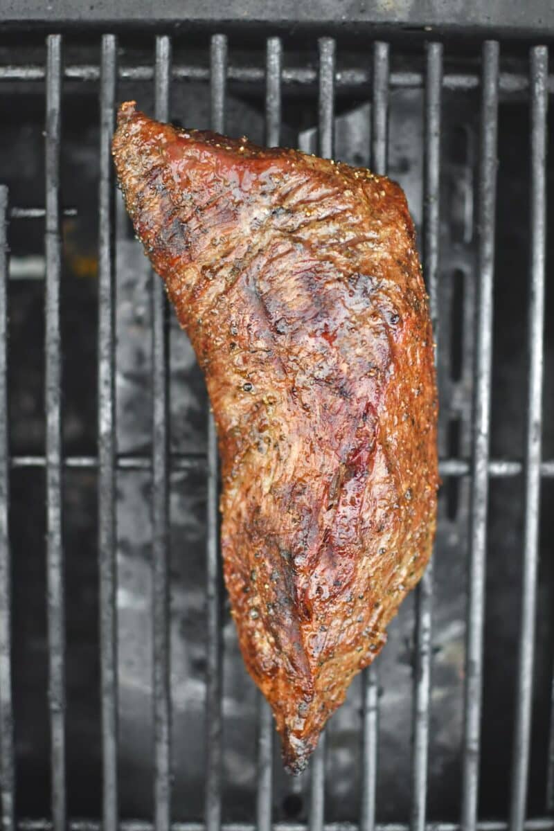 Tri-Tip placed on a hot grill, searing the second side.