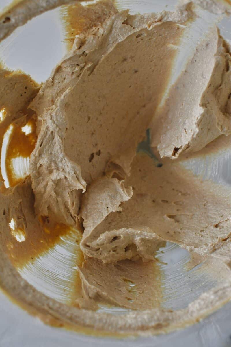 Butter, peanut butter, and sugars in a the bowl of a stand mixer creamed together.