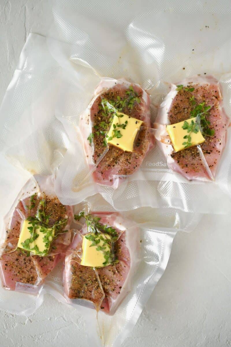 Seasoned pork chops added to vacuum seal bags and sealed up ready for cooking in the sous vide.