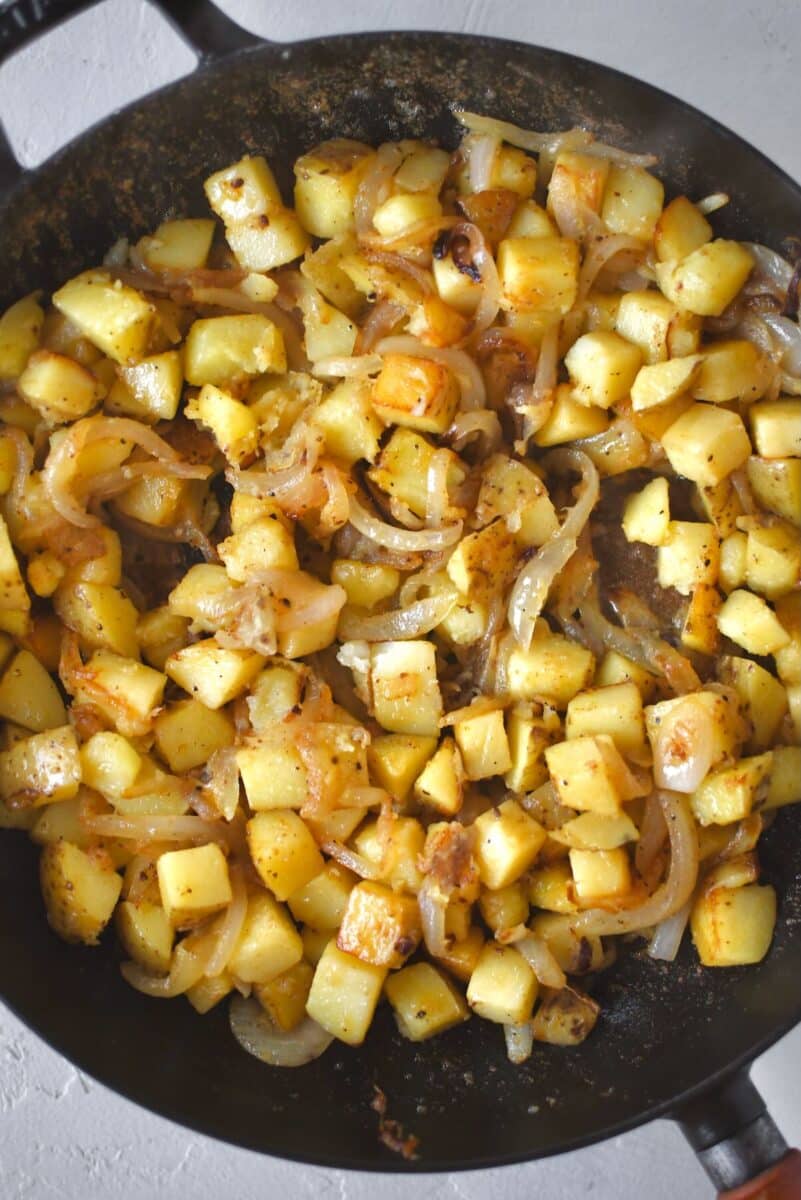 Par cooked potatoes added to the pan and cooked till crisp.
