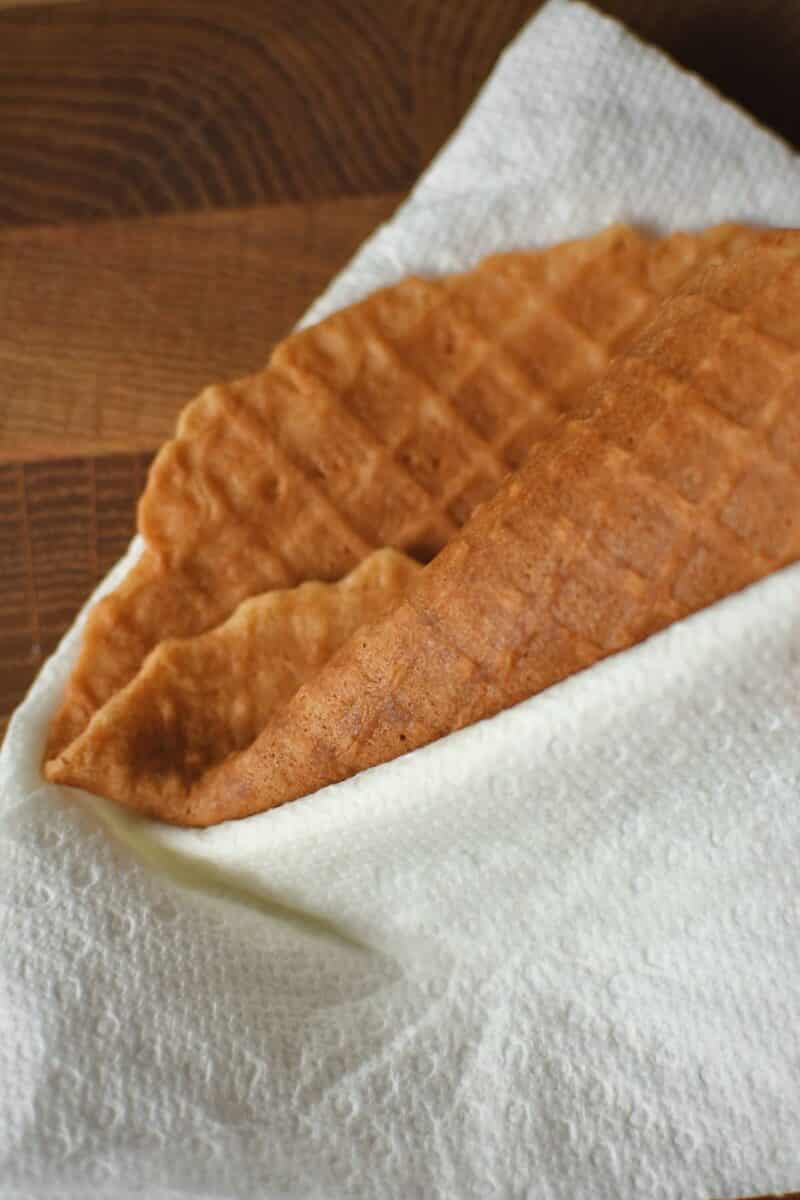 Rolling up a waffle cone, ensuring that I get a fold in the plyable waffle so there is no hole in the bottom.