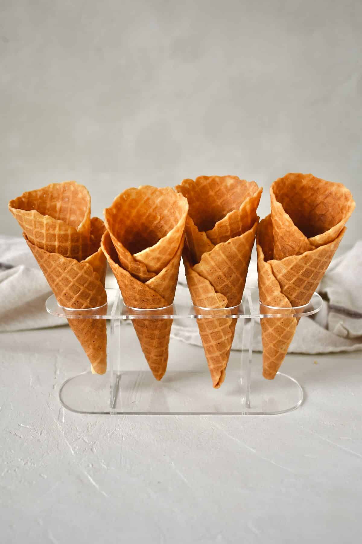 Finished Waffle Cone Recipe resting in a stand and ready to be filled with ice cream.