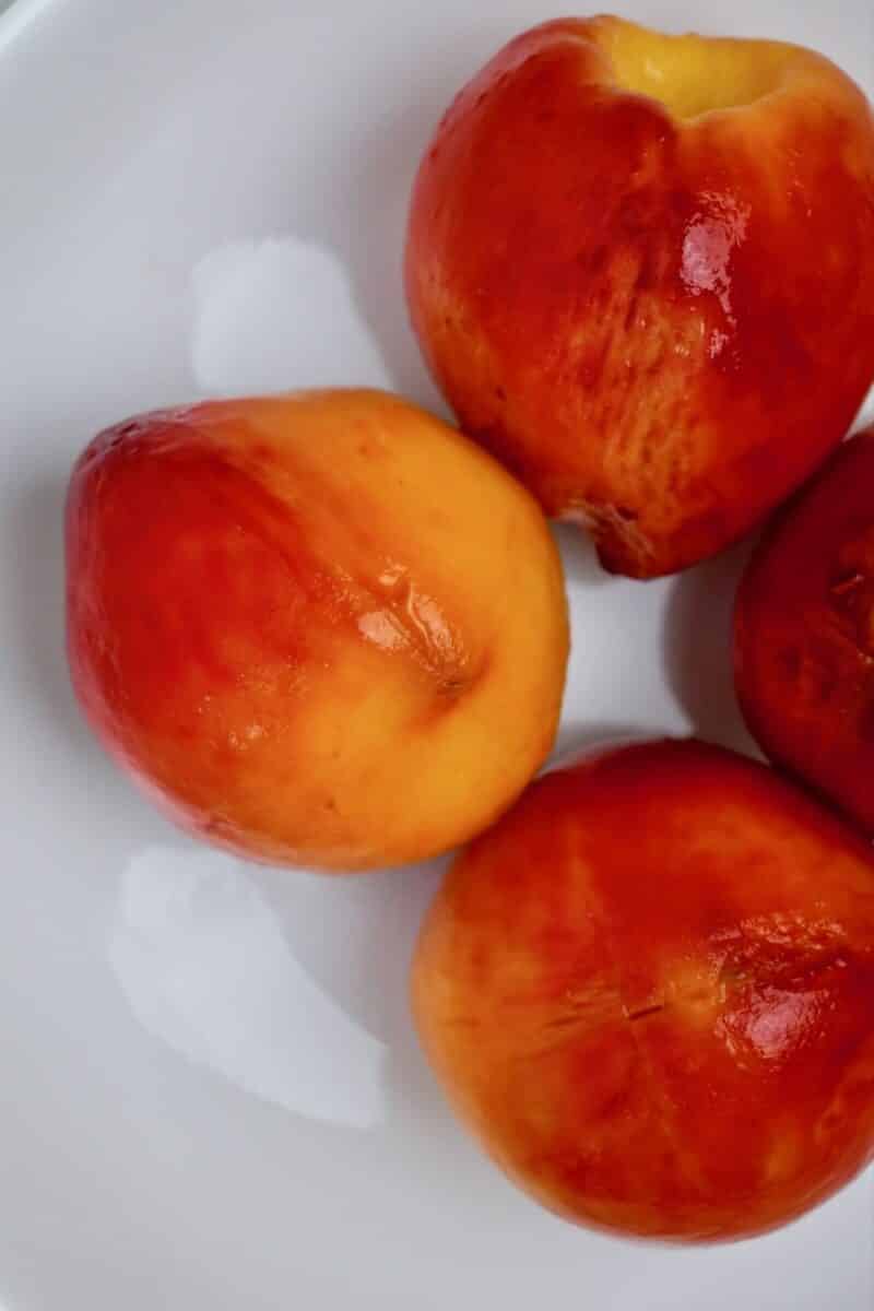 Whole peaches after blanching and peeling.
